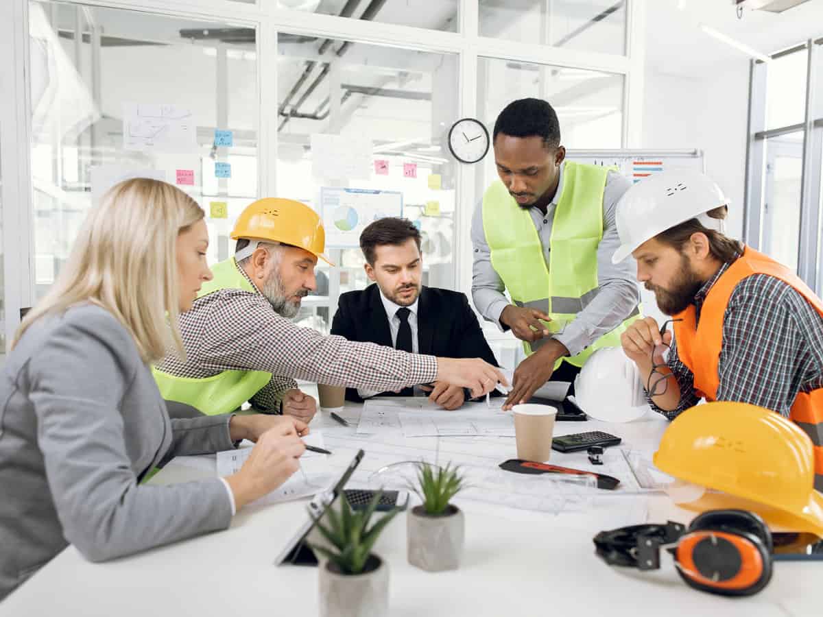 Group of men and women on a job site sitting at a table