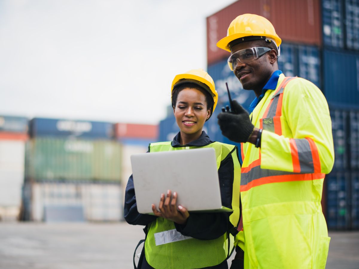 Two project managers use digital solutions to streamline task management.